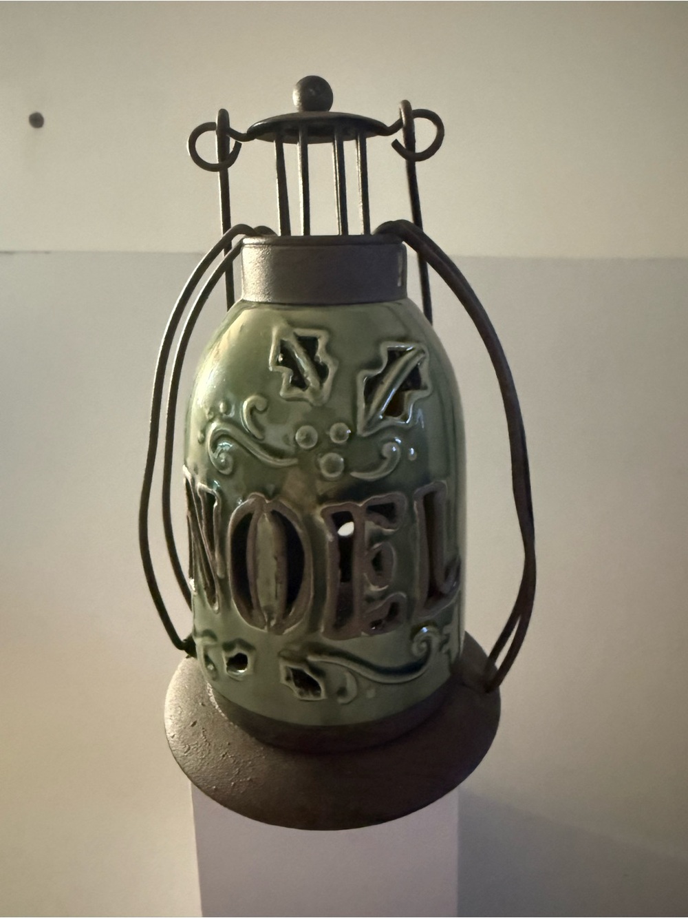 ceramic holiday lantern Green Color with the word
"NOEL" metal cage wire handle